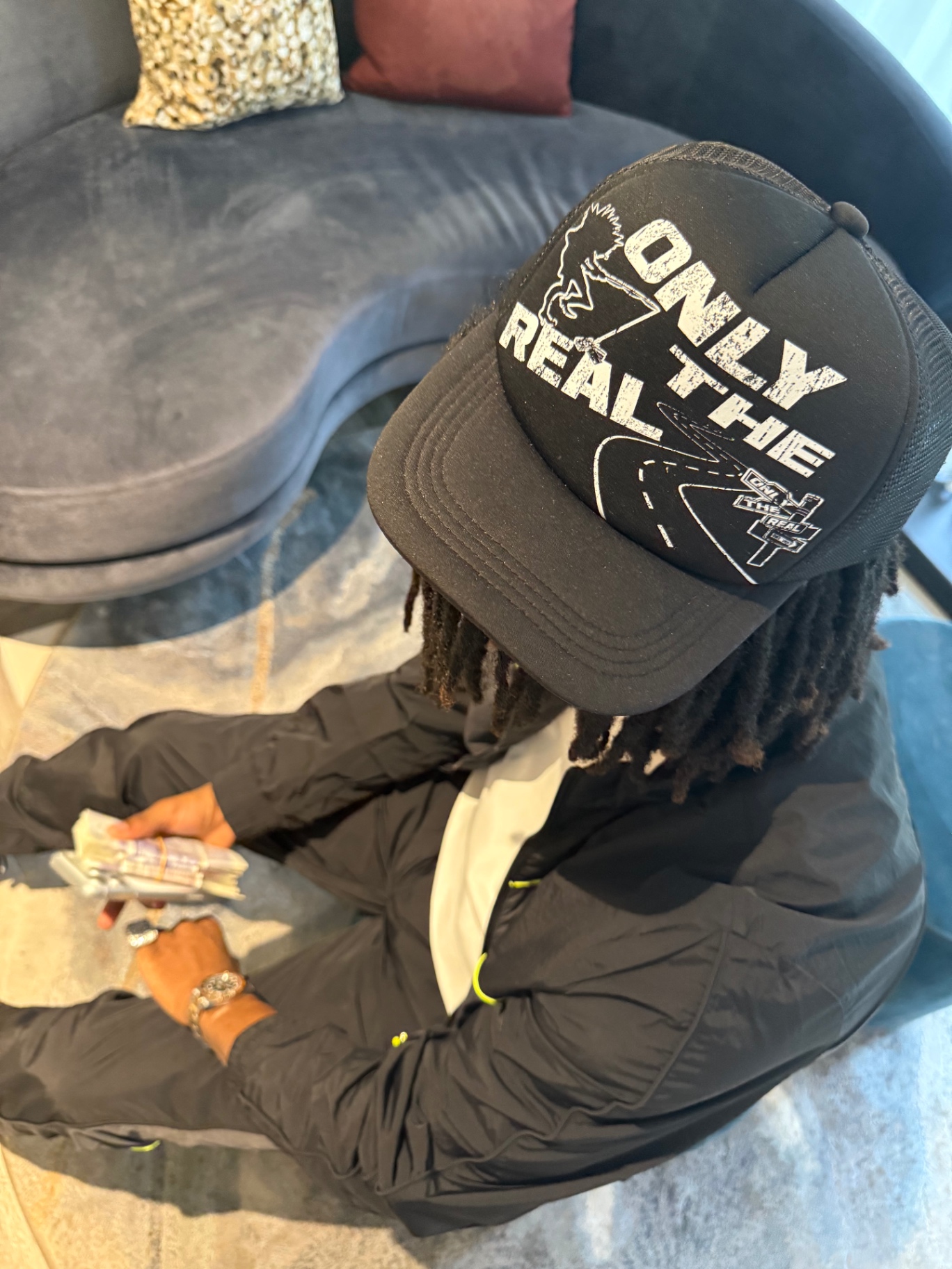 Only The Real cap shown in close-up editorial styling.
